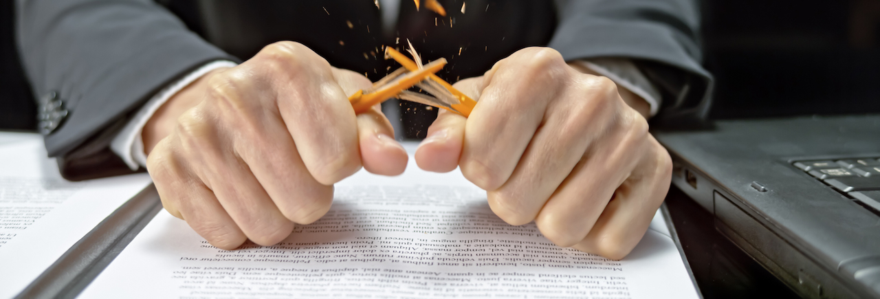 male hands snapping a pencil