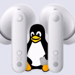 Linux mascot sat between a pair of CMF earbuds